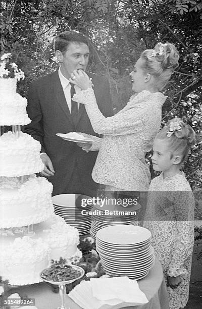 Tippi Hedren and husband are shown at their wedding cake.