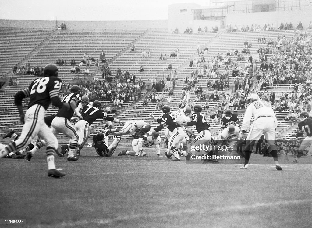 Johnny Robinson Diving Through Air with Football