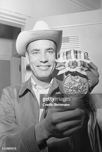 American runner Billy Mills with his gold medal for the 10,000-meter track event, at the Tokyo Olympics, Japan, 23rd October 1964. His was one of the...