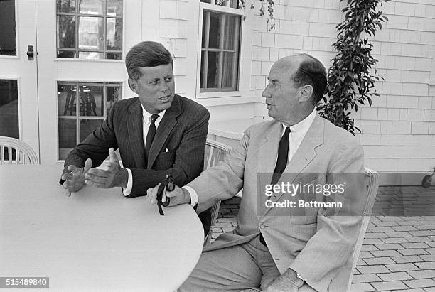Senator John Kennedy, Democratic nominee, left, confers with Adlai Stevenson on porch of Kennedy's house. Stevenson has been mentioned as a possible...