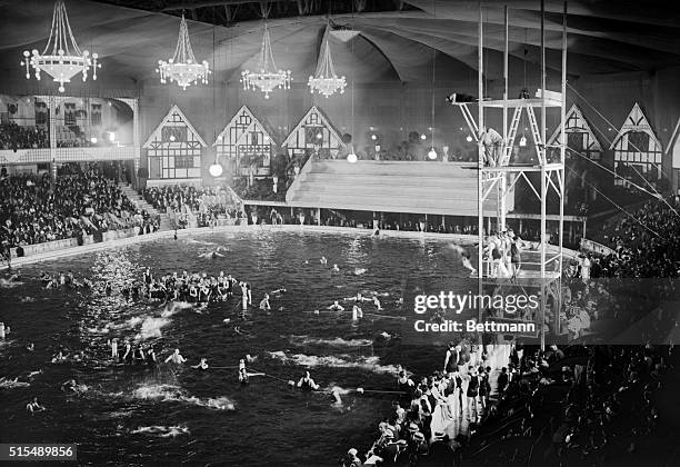 Madison Square Garden transformed into swimming pool scene in Tex Rickard's luxurious indoor swimming pool which was thrown open to the public. June...