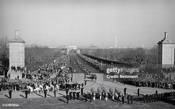 The caisson bearing the body of President Kennedy moves into National Cemetery.