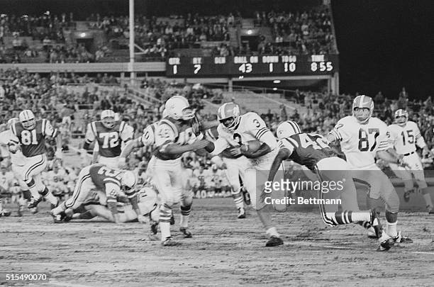Denver Bronco running back Billy Joe steams ahead for six yards as New York Jets Billy Baird and Clyde Washington close in for the tackle in first...
