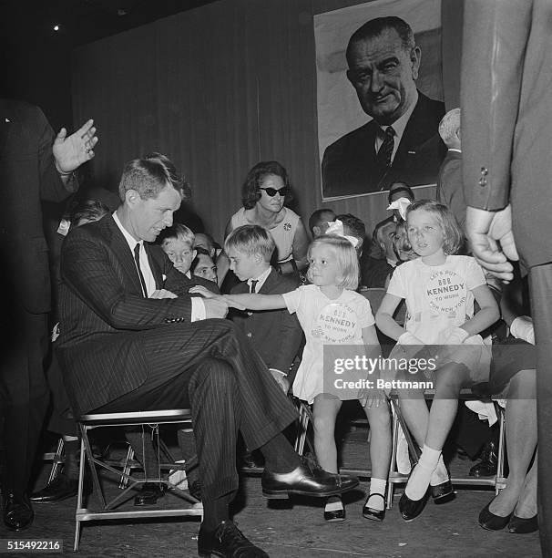 Attorney General Robert Kennedy nominated 1st as the New York Democratic Party's candidate for U.S. Senator, gets a reassuring pat from...