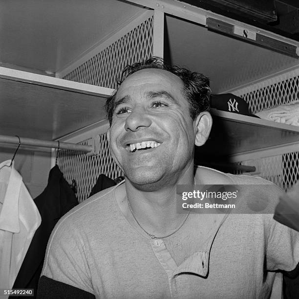 New York Yankees manager Yogi Berra smiles in the locker room after his team defeated the St. Louis Cardinals, 8-3, to tie the World Series at three...