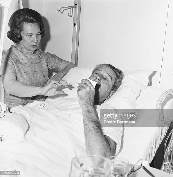 Governor John Connally wipes tears from his eyes while lying in a hospital bed after being shot during the assassination of John F. Kennedy.