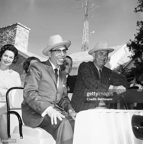 President Lyndon Johnson and Mexican President elect Gustavo Diaz Ordaz both sport the famous Western hats as they tour the Johnson ranch in a golf...