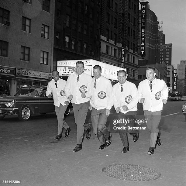 Jogging down Broadway November 29th are the backfield elected on the American Football Coaches Association first team. Keeping in shape are : Gale...