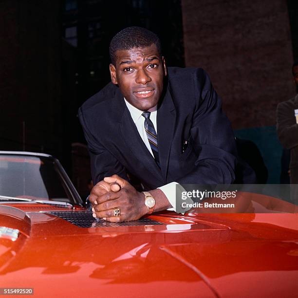 St. Louis Cardinals pitching ace Bob Gibson and his wife, Charlene, happily take possession of a 1965 sports car . Sport Magazine awarded the car to...