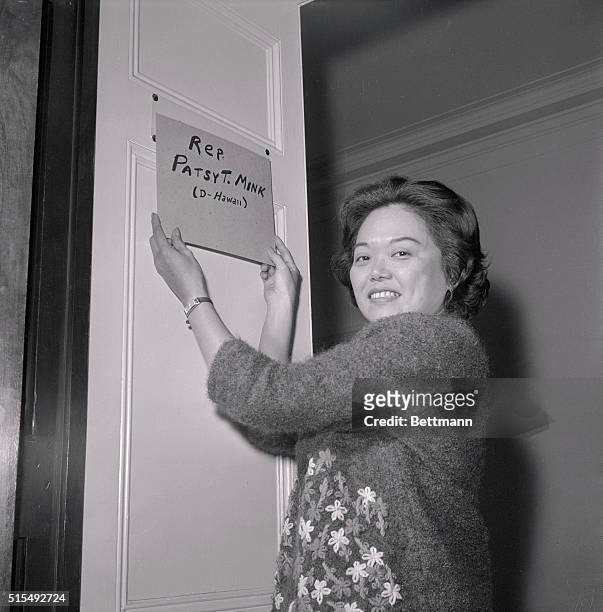 Representative Patsy Takemoto Mink puts homemade nameplate on the door of her new office here January 1st. The only female to be elected to the 89th...