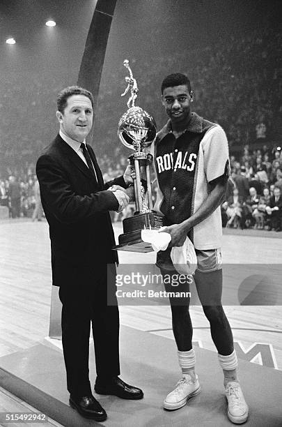 Oscar Robertson is presented with the Most Valuable Player of 1964 by Murray Olderman, sports editor for the NEA. The award was made during halftime...