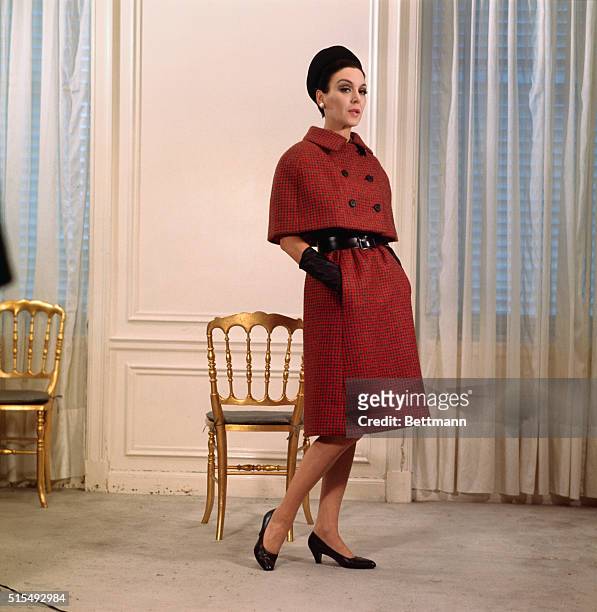 The cape suit...Noting the simplicity of styling that marks the Norman Norell Fall 1964 collection is this "cape suit" done in red and charcoal grey...