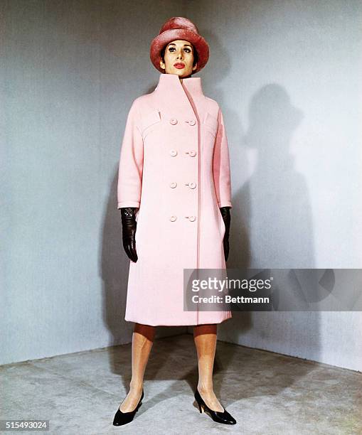 Collared high...Simple lines are made interesting by Paris designer Capucci, when he extends the collar of this coat silhouette up to the chin. The...
