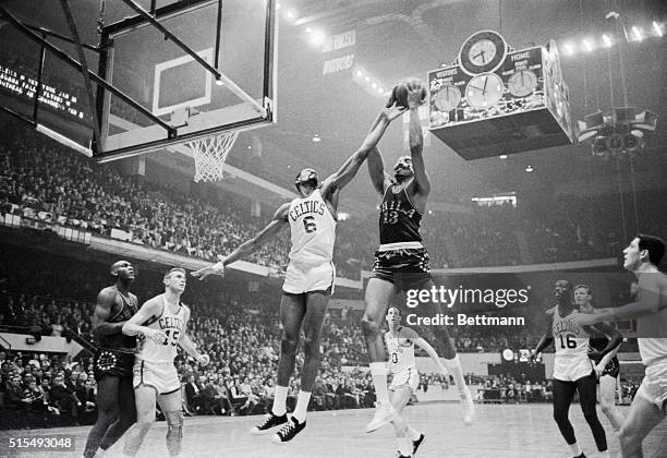 Boston: Celtics' Bill Russell harasses 76ers' Wilt Chamberlain as he attempts to score, 2nd quarter action, Boston Garden. Celtics' John Havlicek .