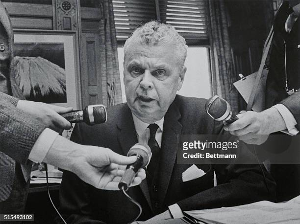 Ottawa: Opposition Leader John Diefenbaker talks to reporters after failing to delay the closure motion on the red maple leaf flag. The Commons early...