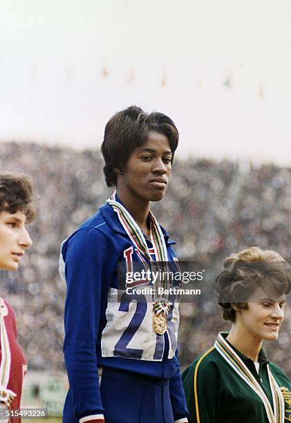 Tokyo, Japan: Winners of the 200 meter dash at the Tokyo Olympic Games. Center is winner Edith McGuire of the US, left is Irena Kirszenstein of...