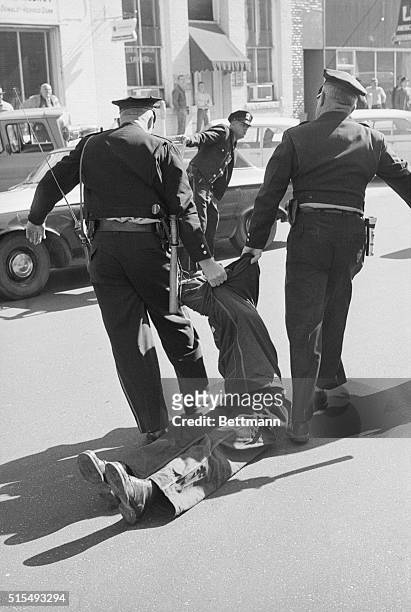 An African-American student, Willie Lawrence McRae, a member of the Student Non-Violent Coordinating Committee of Atlanta, Georgia, is dragged by two...