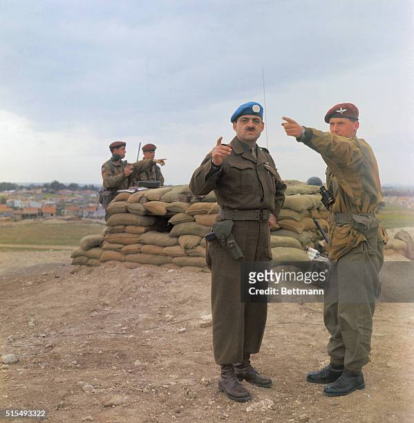 Paratrooper Lt. John Rosier and Major Bob Therriault of the Van Doos on Porkchop Hill studying Greek and Turkish gun posts.