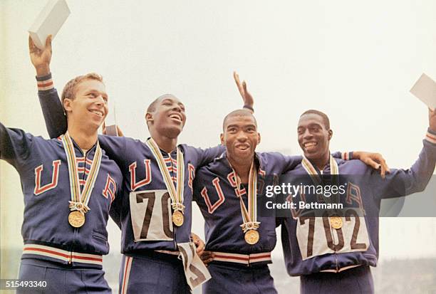 Members of the U.S. Men's 400 meter relay team pose with their gold medals after victory ceremonies during the 1964 Summer Olympic Games in Tokyo,...