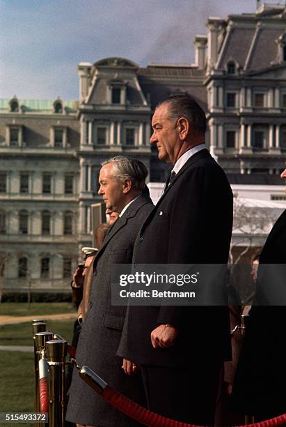 British prime minister Harold Wilson stands with President Lyndon B. Johnson on the grounds of the White House. The Prime Minister received full...