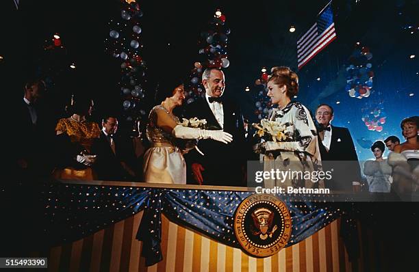 Washington, D.C.: Pres. And Mrs. Johnson are greeted by actress Sally Ann Howes as they arrive at the 1965 Gala which officially opened the Inaugural...