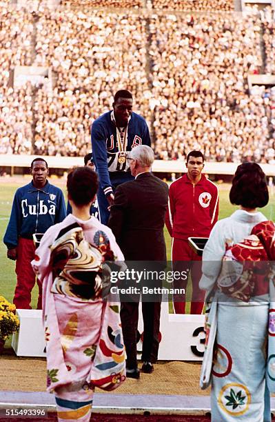 Olympics: Winners of the men's 100 meter run, Bob Hayes, of U.S., first place; Enrique Figuerola, of Cuba, second place; and third place Harry...