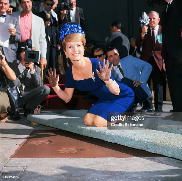 Color on actress Debbie Reynolds putting her handprints, footprints, and autograph in cement in the patio of the Graham Chinese theater in Hollywood....