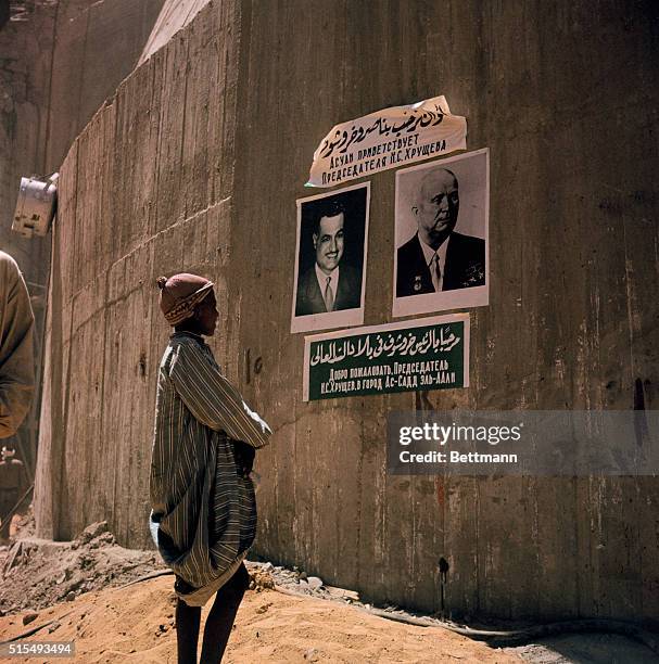 Aswan, where last gap in upstream coffer dam was closed is shown with last preparations, dam entrance and exit, and show of workers.