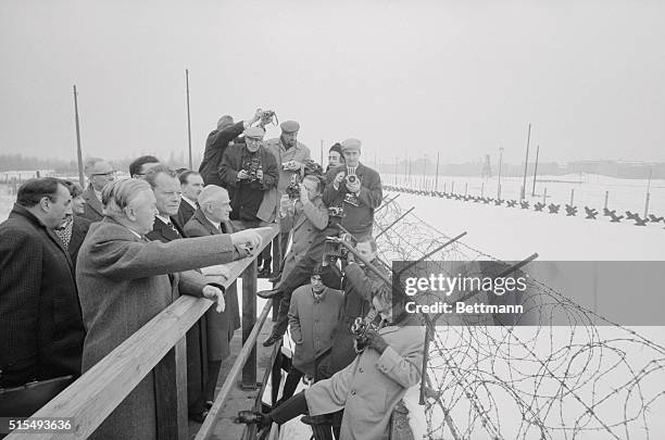 Wilson at the Wall. West Berlin: British Prime Minister Harold Wilson looks over the barbed wire atop the Berlin Wall as he tours the divided city,...