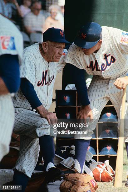 New York Mets skipper Casey Stengel speaks with rookie outfielder Ron Swoboda in the dugout during the team's first spring training game against the...