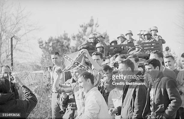 March 21, 1965-Selma, Alabama: Truck load of MP's keeps eye on group of whites who display Confederate flag while taunting civil rights marchers on...