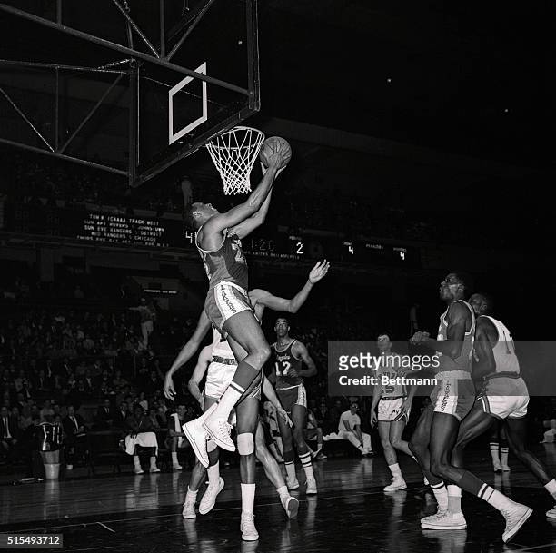 Elgin Baylor , of the Los Angeles Lakers, goes in for a layup from behind the basket during game with the New York Knickerbockers at Madison Square...
