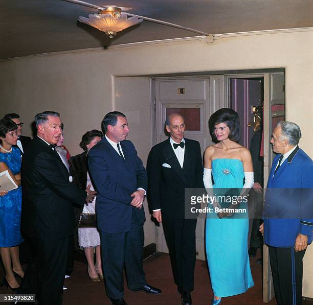 New York: Mrs. John F. Kennedy is escorted by Metropolitan Opera General Manager Rudolf Bing during intermission at the Met. Mrs. Kennedy and other...