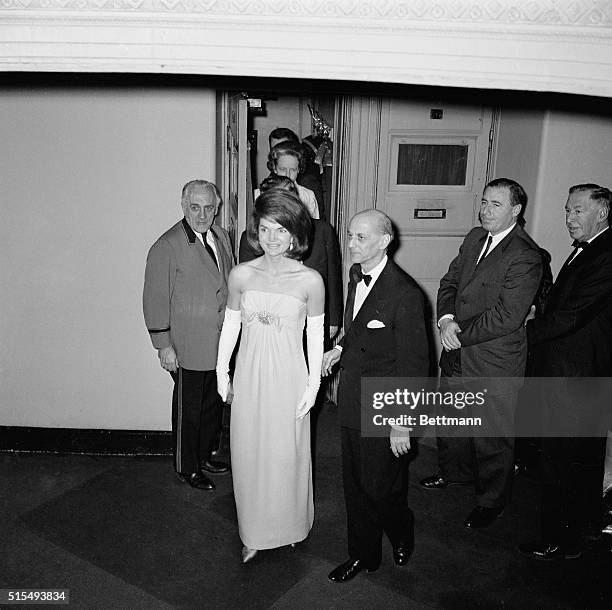 Mrs. John F. Kennedy is escorted by Metropolitan Opera manager Rudolf Bing during intermission. Mrs. Kennedy was on hand for the return of soprano...