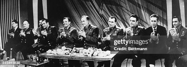 Soviet cosmonauts and one of their chiefs join in general applause during a television appearance here recently, according to the official Soviet...