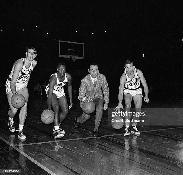 Led by coach Bob Cousy, members of the Boston College basketball team practice dribbling during a workout at Madison Square Garden 3/11 in...