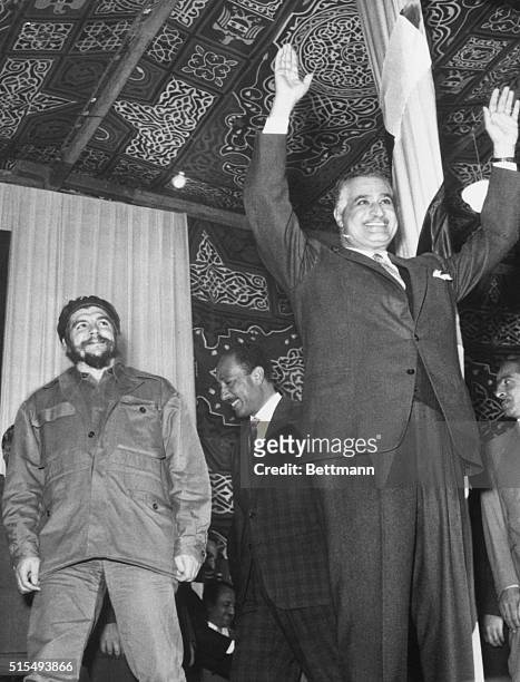 Cairo, Egypt: Egypt's President Nasser gestures to a crowd, as visiting Cuban Industry Minister Ernesto Guevara, , looks on admiringly.
