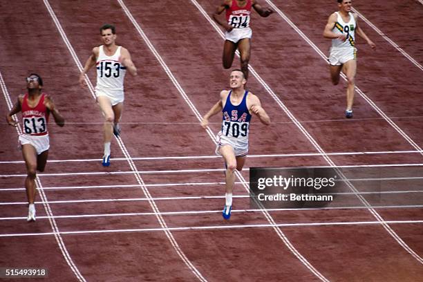 Mike Larrabee of US breaking the tape as he comes in first in the Men's 400 meter run. He is no. 709.