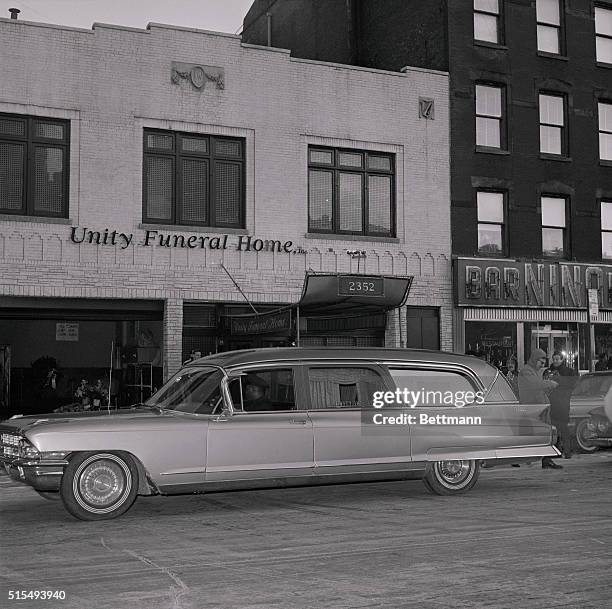 The hearse containing the body of Malcolm X pulls up in front of the Unity Funeral Home here, where a wake for him will be held. The body of the 39...
