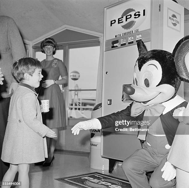"John John" Kennedy reaches out to shake hand with Mickey Mouse during a visit to the Pepsi Cola Pavilion at the World's Fair. The late President's...
