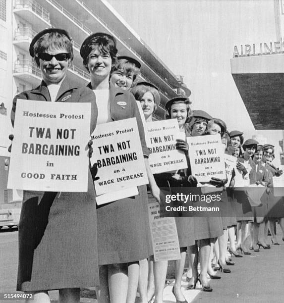 Twenty uniformed Trans World Airlines flight attendants picket in San Francisco for the right to fly at age 35. The attendants, threatening to...