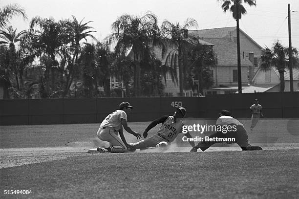 Everybody stretches--but Pittsburgh right fielder Roberto Clemente is out at second after he attempted to steal when St. Louis catcher Bob Uecker...