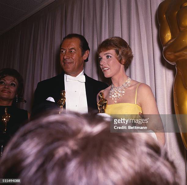 Santa Monica, California...Actor Rex Harrison, winner of an "Oscar" for his performance in My Fair Lady stands with Julie Andrews who won her "Oscar"...