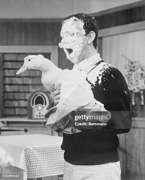 Photo shows comedian Soupy Sales, holding a duck with whip cream smeared all over his face. 1965 file photo.