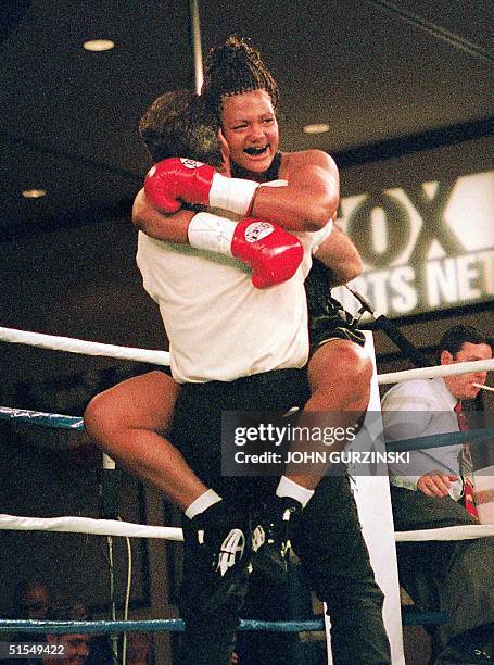 Freeda Foreman , daughter of famed boxer George Foreman, celebrates as she hugs her trainer Larry Goosen after winning her first professional fight...