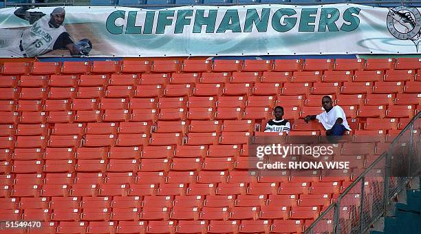 Two Florida Marlins' fans enjoy a section to themselves as they watch the Milwaukee Brewers' play the Florida Marlins pitcher 19 June 2000 at Pro...