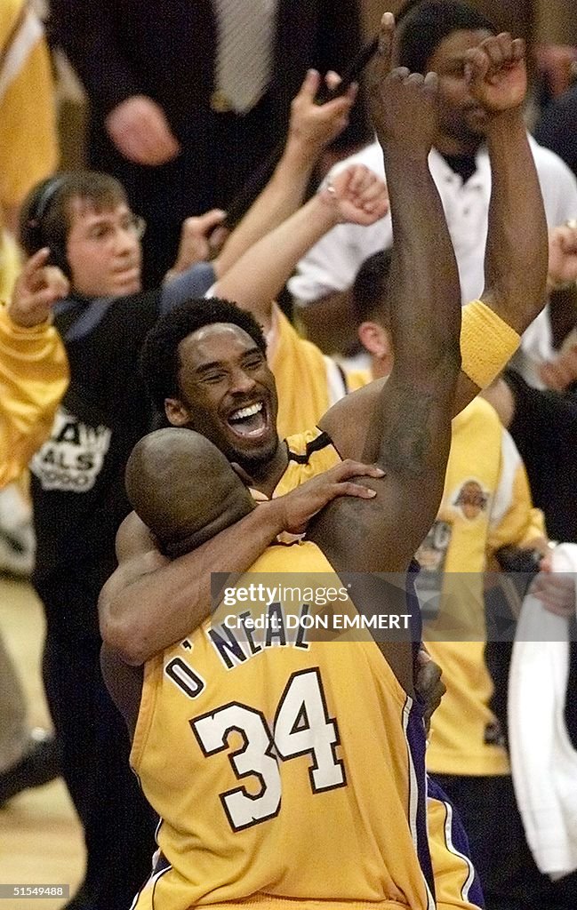 Kobe Bryant jumps into the arms of Shaquille O'Nea