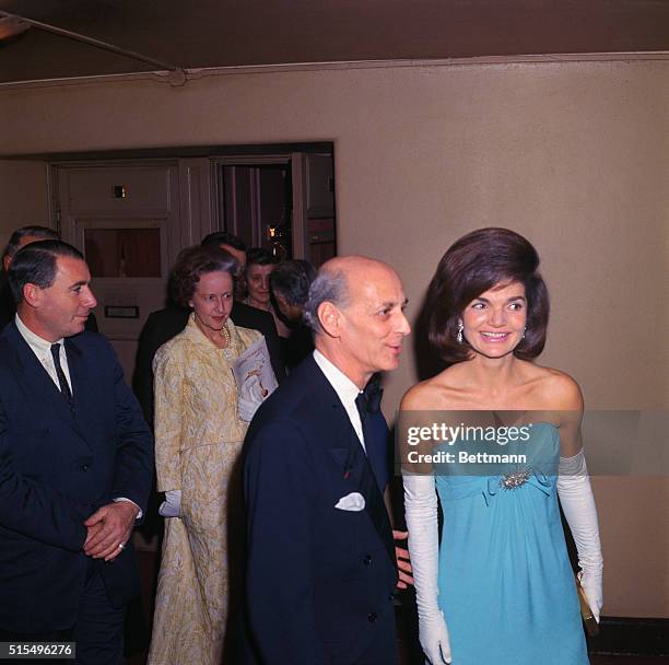 New York: Mrs. John F. Kennedy is escorted by Metropolitan Opera General Manager Rudolf Bing during intermission at the Met. Mrs. Kennedy and other...