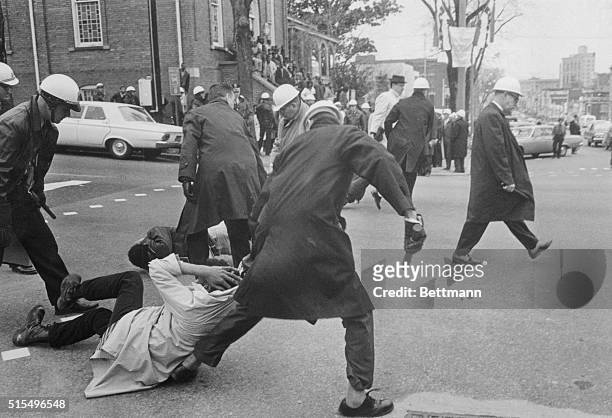 Montgomery police drag African American protesters practicing passive resistance down Dexter Avenue, where several of them lay down. Four were...