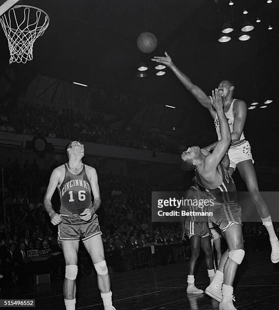 Philadelphia, Pennsylvania: Philadelphia 76er Wilt Chamberlain collides with Cincinnati Royals, Wayne Embry , as the giant 76er attempts to make the...